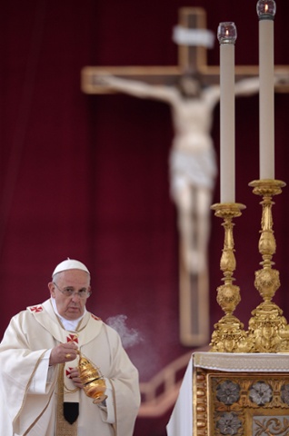 Pope Francis swings the censer during the canonisation mass.