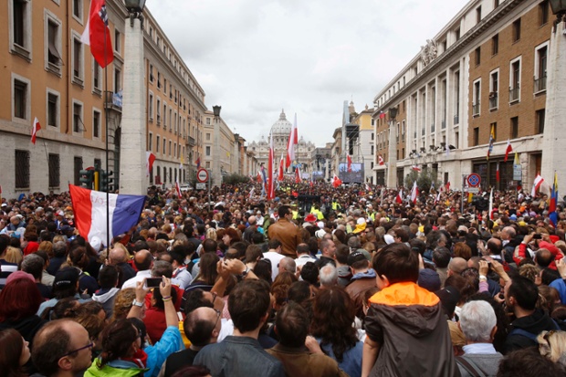 People crowd into Via della Conciliazione, the avenue leading up to the Vatican.