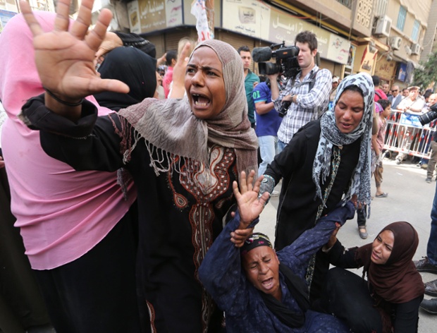 Relatives react outside a court during the trial of supporters of former president Mohamed Morsi in Minya, Egypt. The court sentenced 683 supporters to death.