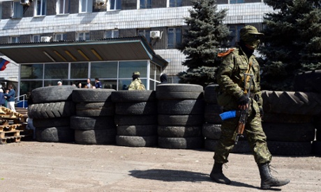 Armed men stand guard in front of a regional administrative building seized last night by pro-Russian separatists in the eastern Ukrainian city of Konstantinovka.