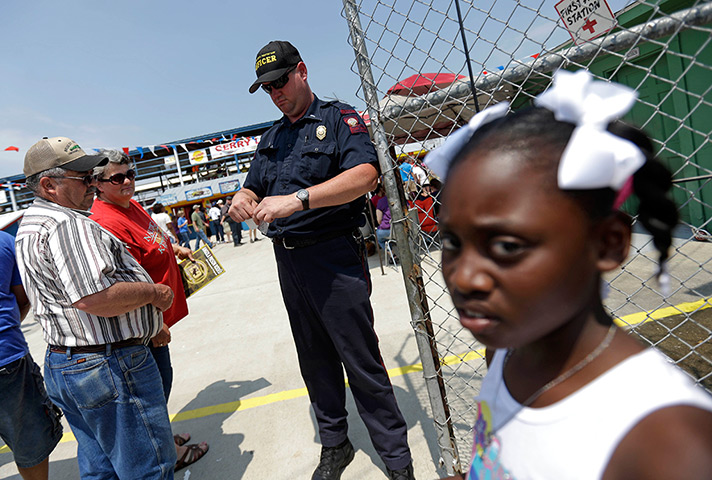 FTA: Angola Prison Rodeo: A guard takes tickets as people enter the Angola prison rodeo in Louisiana