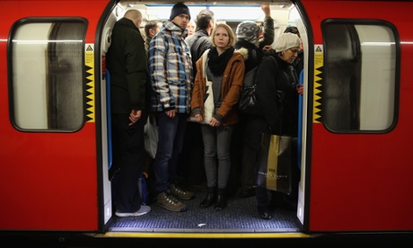 Commuters crowd on to a tube at Oxford Street station