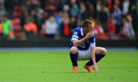 James McCarthy kneels down, looking dejected