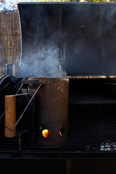 Pitt cue BBQ home smoker: The chimney starter smoking.