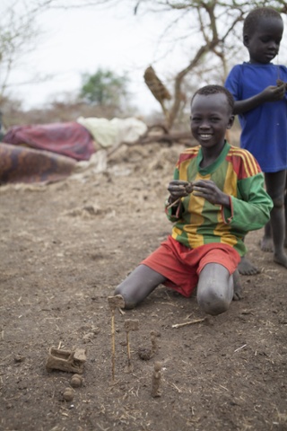 Two South Sudanese children play with toys made from mud in Kule refugee camp in the Gambela region of Ethiopia.