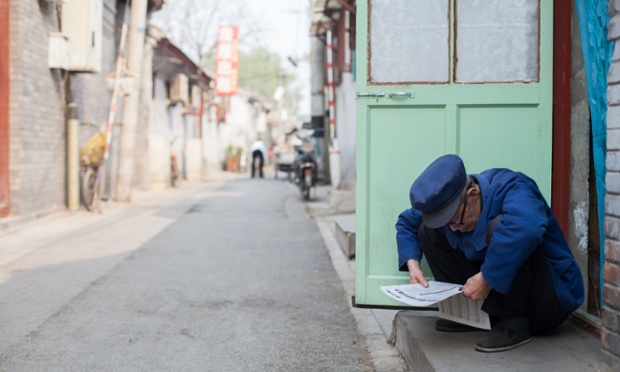 A man sits in a Hutong (alley) near the Tiananmen Square in Beijing, China.