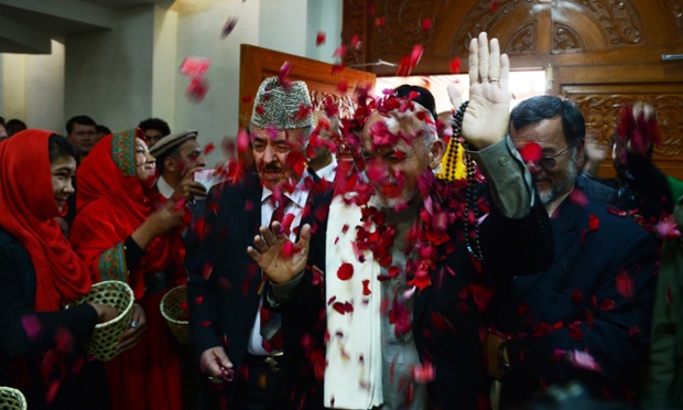 Afghan presidential candidate Ashraf Ghani Ahmadzai is showered with flower petals as during a rally as 12 million Afghans will go to the polls on 5 April.