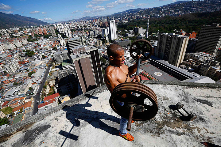 Tower of David: A man lifts weights on a balcony on the 28th floor