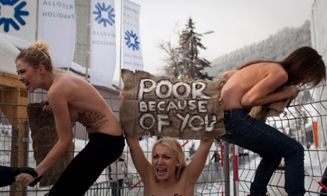 Jan. 28, 2012 photo by Associated Press photographer Anja Niedringhaus. Topless Ukrainian protesters climb up a fence at the entrance to the congress centre where the World Economic Forum takes place in Davos, Switzerland.