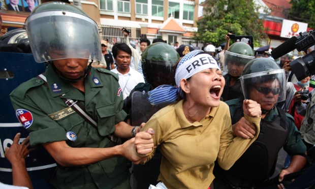 A protester is taken away by police officers during a demonstration in front of the Phnom Penh Municipal Court in Cambodia. Demonstrators demanded the release of 21 detainees who have been jailed since January 3, when military police opened fire on workers striking over low pay, killing four people.