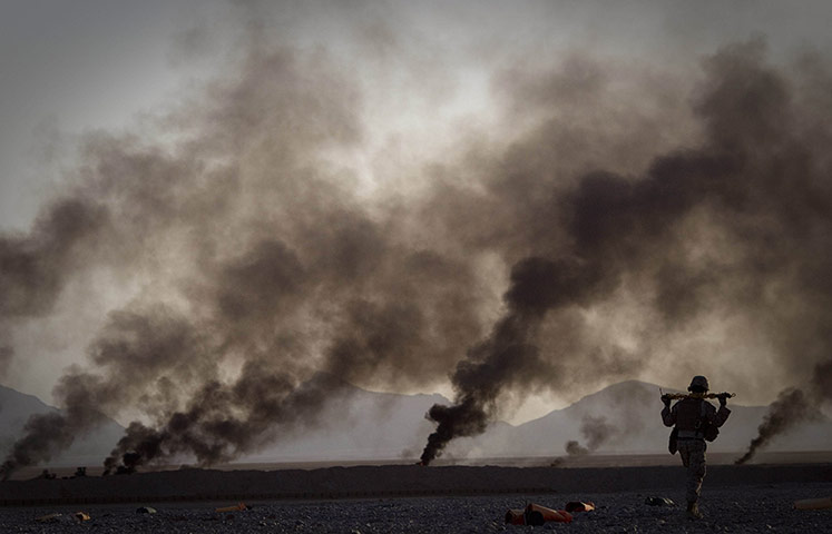 20 Photos: A US Marine walks towards food supplies in Helmand province, Afghanistan