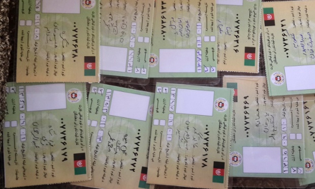 Fake election voter cards are photographed in Jalalabad. The Taliban have launched a violent campaign to disrupt this weekend's presidential election in Afghanistan, but in a restive eastern corner of the country they are paying villagers to surrender their voting cards.