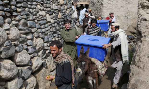 Afghan election workers carry ballot boxes and election materials on donkeys to deliver to polling stations in Dara-e-Noor district of Jalalabad, east of Kabul