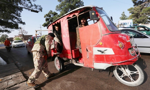 Afghan security officials inspect  vehicles at a roadside checkpoint in Herat as security increases on the eve of presidential elections. Photograph: Jalil Rezayee/EPA