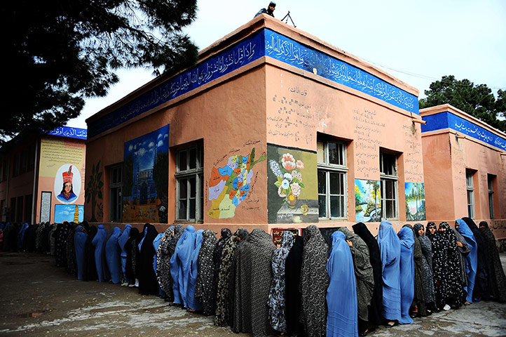 Afghan: Afghan women queue outside a school to vote in the northwestern city of Her
