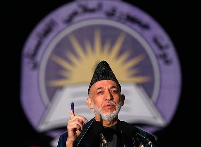 Afghan: Afghanistan President, Hamid Karzai holds up his inked stained finger 