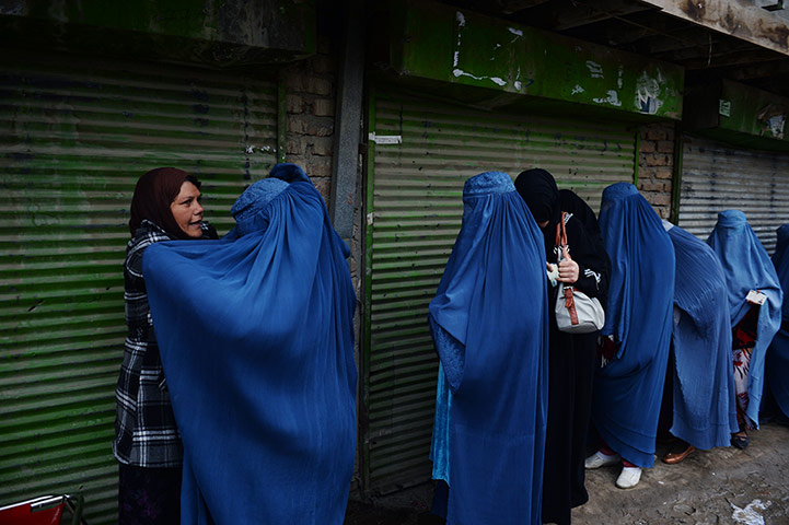 Afghan: An official frisks female voters