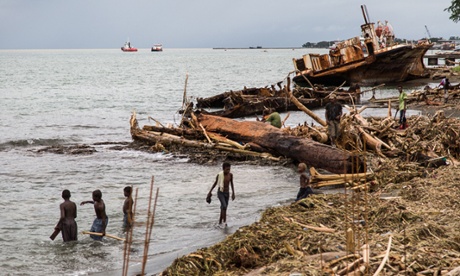 People search through the debris on the beach near the Solomon Islands capital of Honiara.