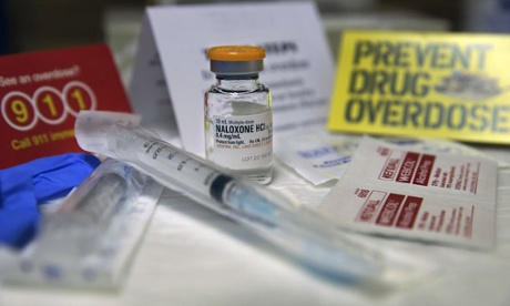 A kit with a vial of naloxone