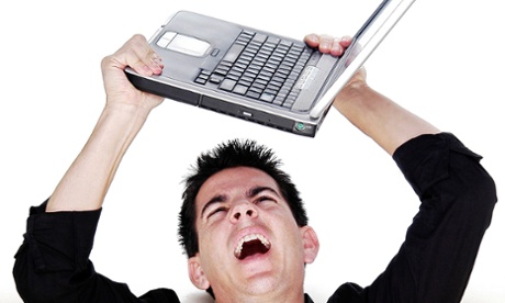 Angry man holding laptop