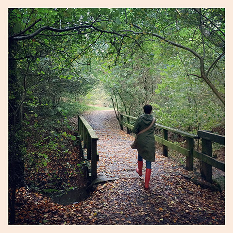 In pictures: Chic: Woman walking through park in red wellies