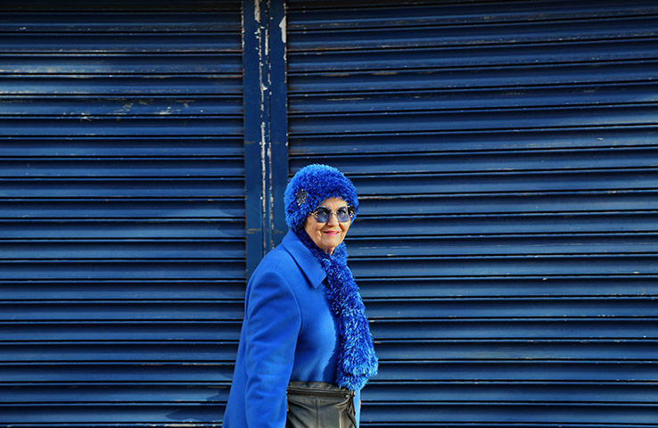 In pictures: Chic: Old woman in blue hat against blue shutters