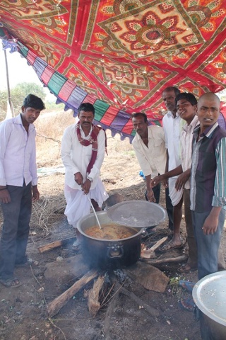 'Men cooking food for community festival meal in rural Andhra Pradesh.'