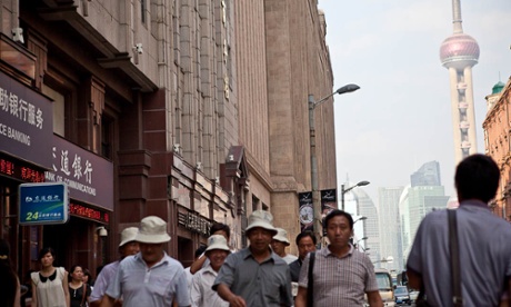A Shanghai street with the Pearl Tower behind it.