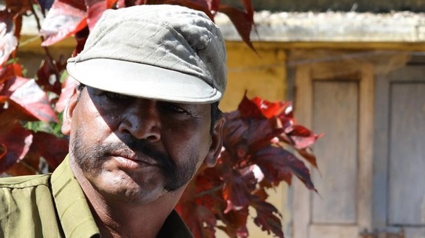 'A forest ranger strikes a pose during an interview.' - near Trichy, Namakkal Road.