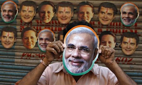 A vendor wears a mask of Modi in Chennai