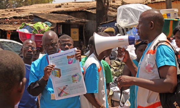 Health workers teach people about the Ebola virus and how to prevent infection, in Conakry, Guinea