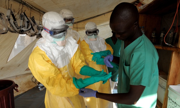 Health specialists work in an isolation ward for patients at the Doctors Without Borders facility in Guekedou, southern Guinea.