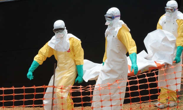 Staff of MSF carry the body of a person killed by viral haemorrhagic fever, at a center for victims of the Ebola virus in Guekedou, Guinea