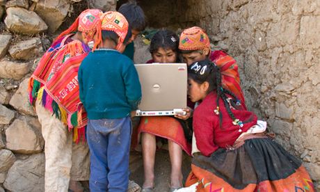 Peruvian children looking at laptop, Ollantayambo, Peru.