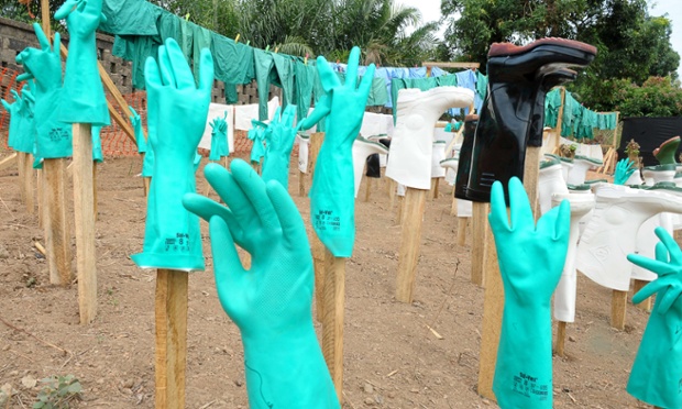 A view of gloves and boots used by medical staff, drying in the sun, at a center for victims of the Ebola virus in Guekedou