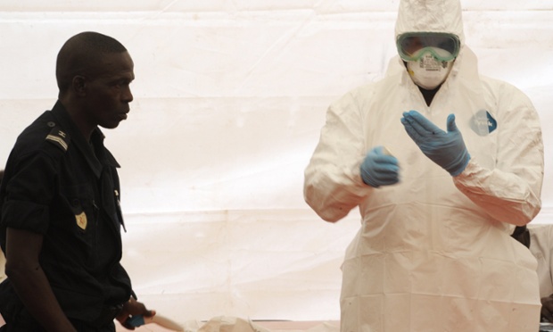 A Senegalese hygienist demonstrates how to protect oneself against the Ebola virus at Dakar airport, during a visit of the Senegalese health minister to check the safety measures put in place to fight against the virus