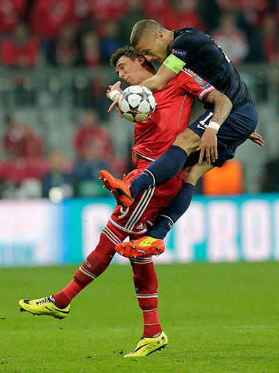 Bayern v United: Nemanja Vidic climbs over Mario Mandzukic 
