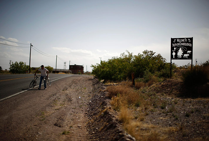From the agencies: A man carries a broken bicycle in Truth or Consequences
