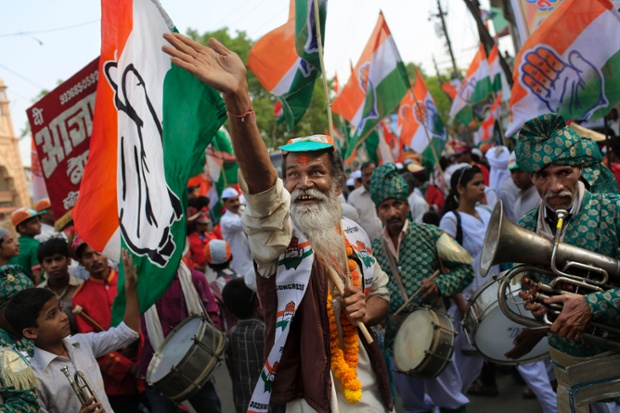 Supporters of India's ruling National Congress party dance during an election campaign rally in Varanasi.