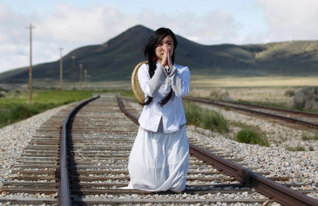 A woman says a prayer for her ancestors on the railway tracks they helped to build, during celebrations the 145th anniversary of the completion of the Transcontinental Railroad, at Promontory Point, Utah, USA.