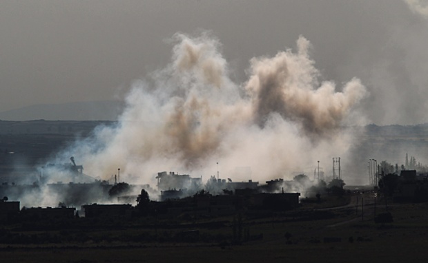 Smoke rises from the rebel-captured village of Quneitra after artillery shelling by the Syrian army.