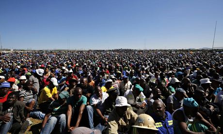 Striking platinum miners attend a rally near Lonmin's Marikana mine