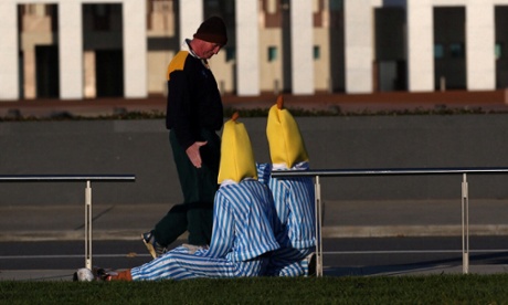 Senator Barnaby Joyce greets some protesting Bananas in Pyjamas out the front of Parliament House in Canberra this morning as the government prepares to deliver its first Budget.