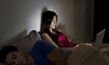 Woman using a computer in bed