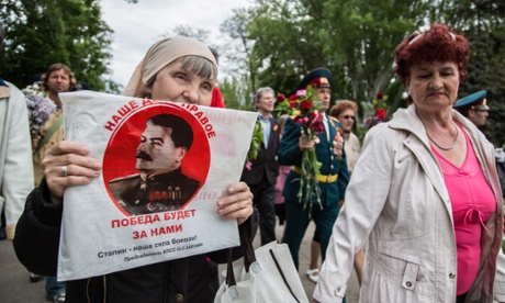 A woman carries a protrait of Stalin during Victory day celebrations in Odessa.