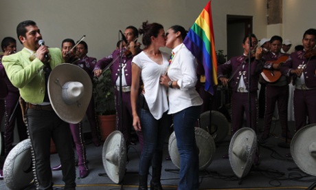 Gay couples celebrate as a mariachi band performs after getting married at a courthouse in Mexico City, Sunday, July 14, 2013.