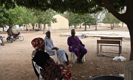 Yerima Pudza, Asabe Kwambura and Bulama Modu sit under a tree