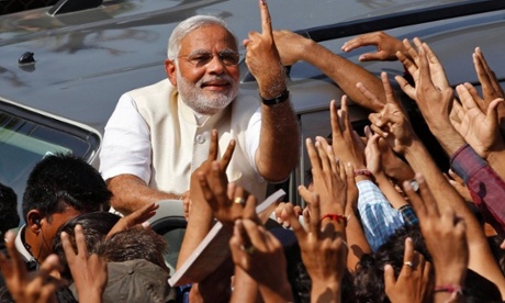 Hindu nationalist Narendra Modi, the prime ministerial candidate for India's main opposition Bharatiya Janata Party (BJP), shows his ink-marked finger to his supporters after casting his vote at a polling station during the seventh phase of India's general election in the western Indian city of Ahmedabad.