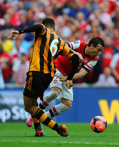 the cup final: Santi Cazorla is brought down by Curtis Davies in the area