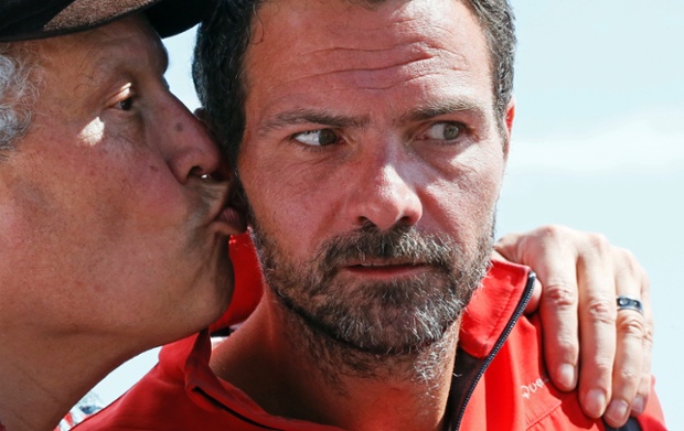 Former trader Jérôme Kerviel, is kissed by a supporter as he arrives at the Italian side of the border with France
